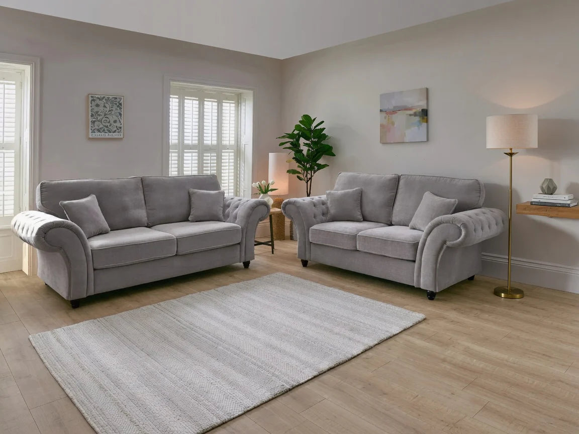 Light gray upholstered sofa set in modern living room.