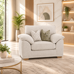A light beige armchair with two throw pillows