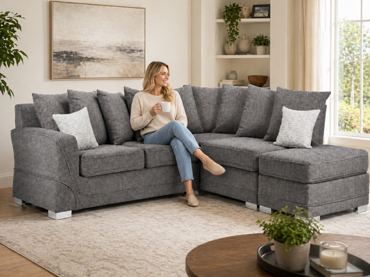 Woman sitting on a gray sectional sofa