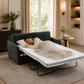 A woman sleeping on a dark green sofa bed with white mattress