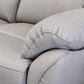 Close-up of a light gray upholstered recliner chair 